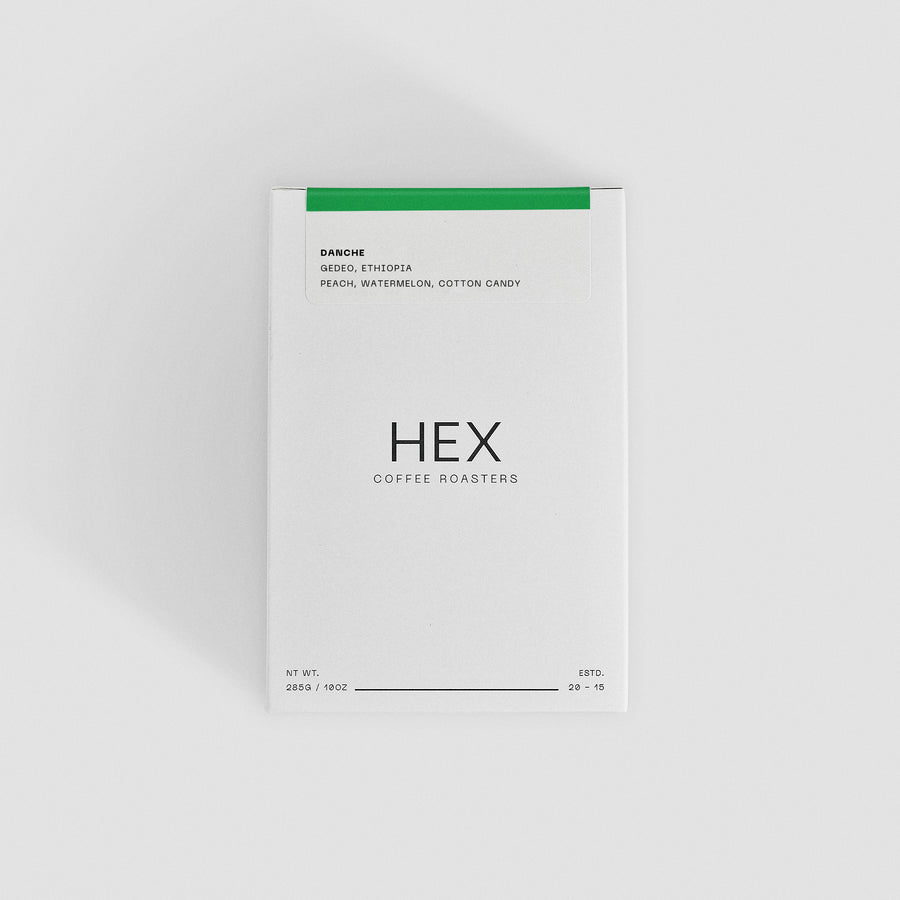 A white bag of coffee beans from Rosso Coffee Roasters